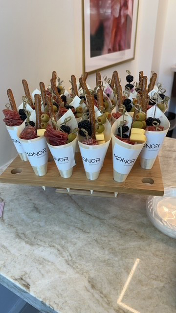 Manor Scottsdale branded charcuterie cones at a resident event